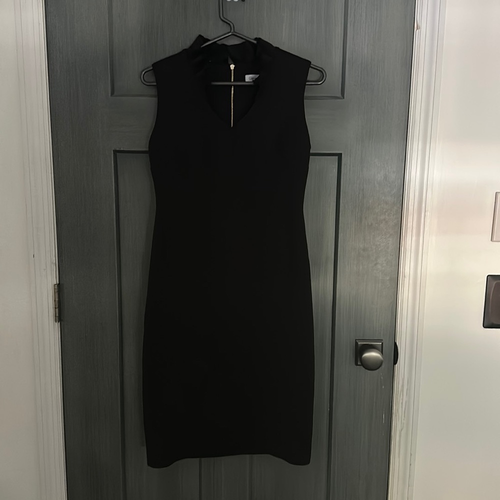 Calvin Klein | black dress, slightly below knee, ruffled v neck, gold zipper